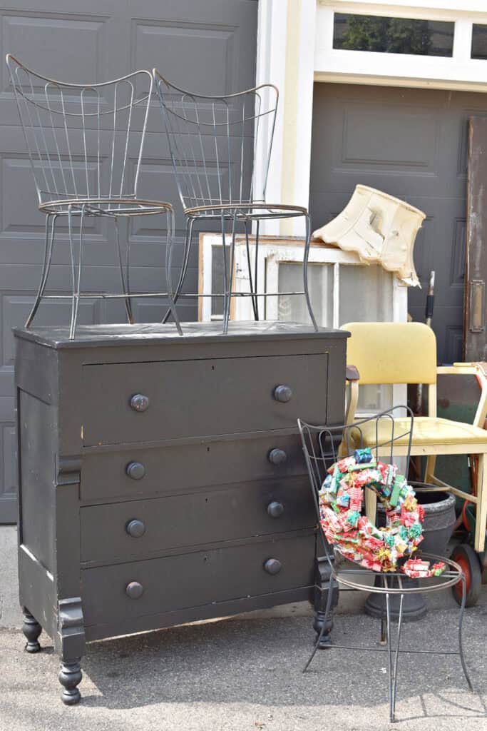 Vintage black empire dresser and black metal chairs.
