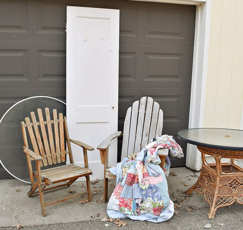 Outdoor wooden yard chairs and wicker table.