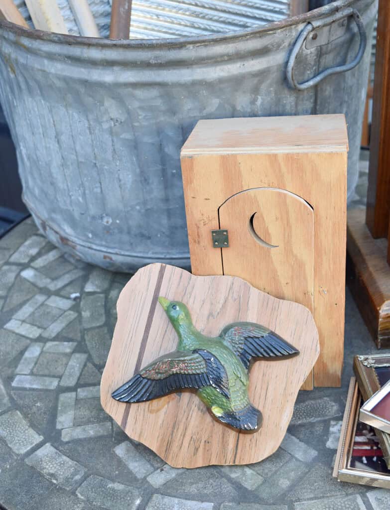 Handmade moon outhouse and duck art.
