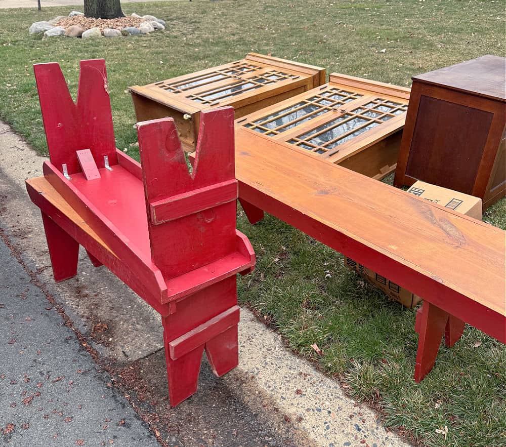 Old furniture in curbside trash pile.