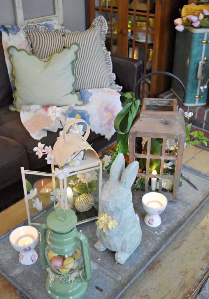 Lanterns with Spring decor on coffee table.