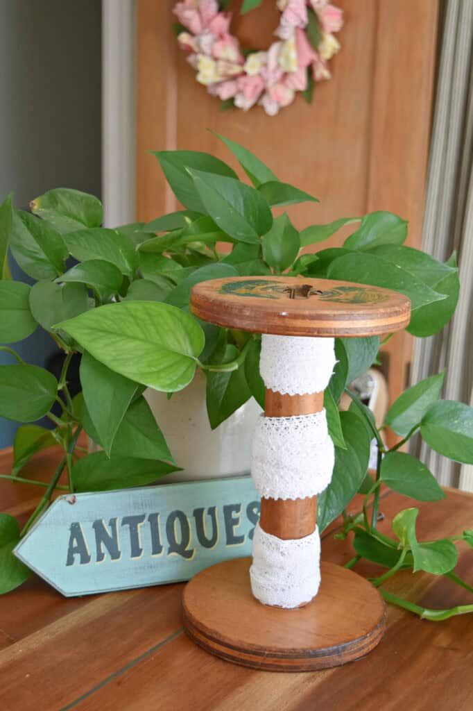 Lace edging on vintage wooden spool.