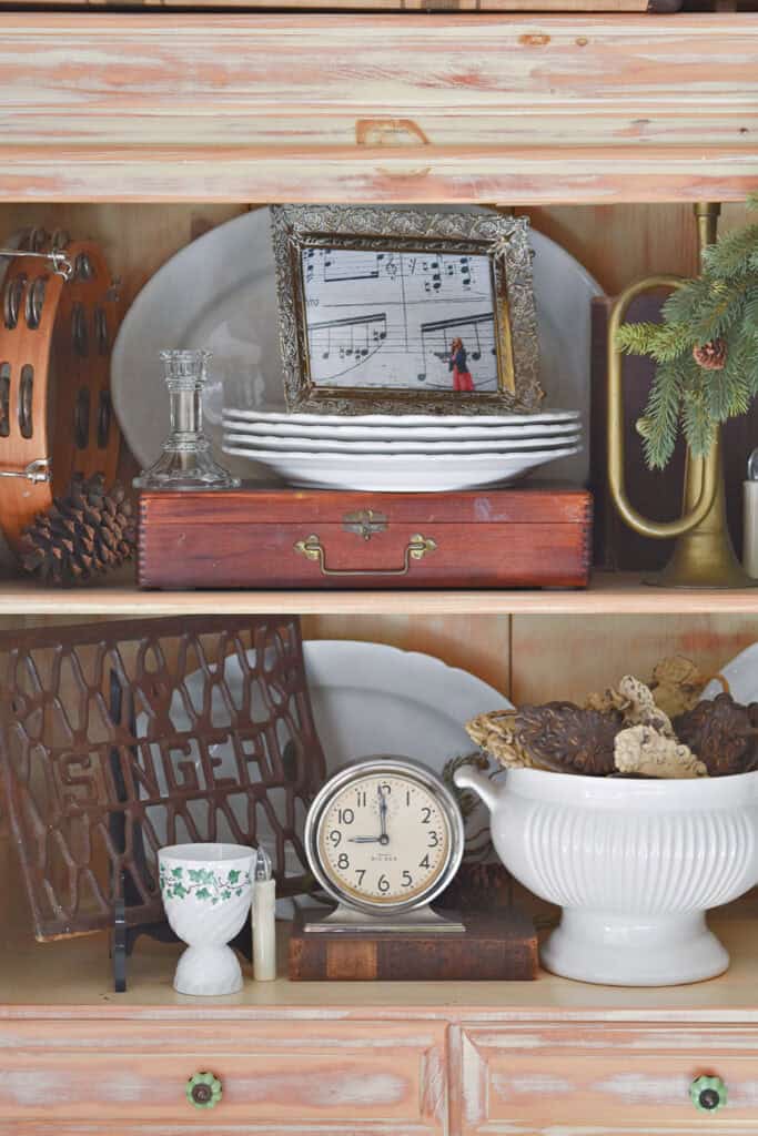 Vintage finds displayed in hutch with music themed accessories.