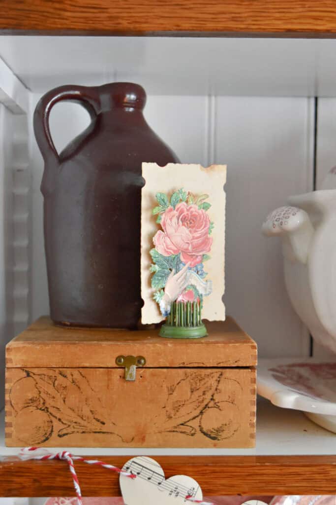 Vintage wooden box with stoneware jug on top.