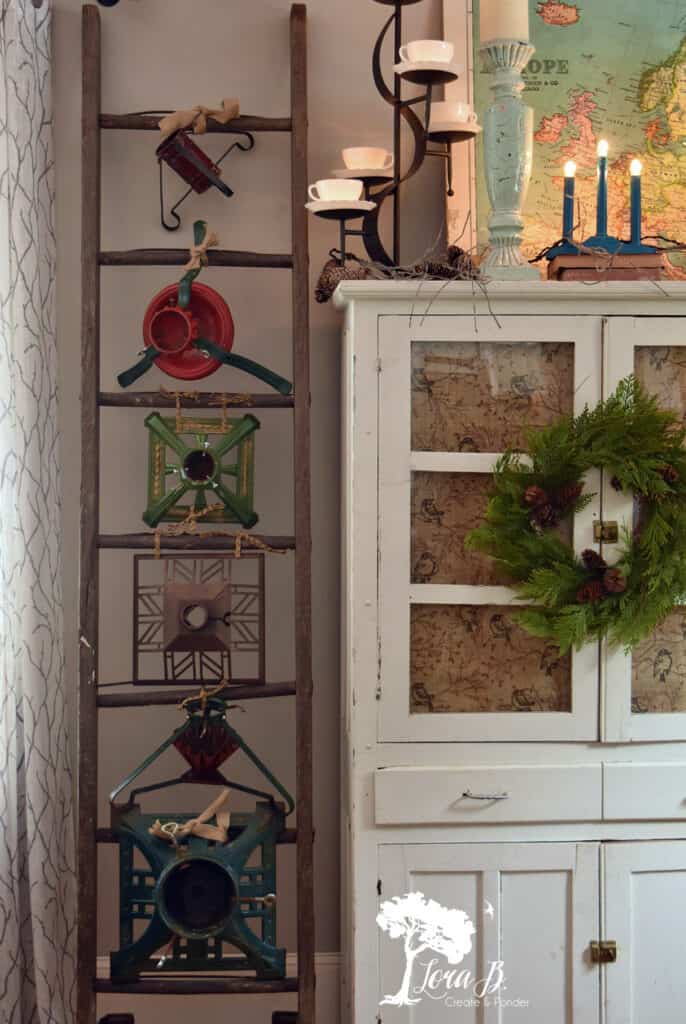 Vintage Christmas tree stand collection displayed on a ladder