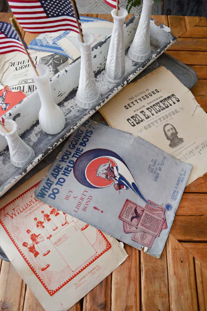 Vintage patriotic sheet music as centerpiece.