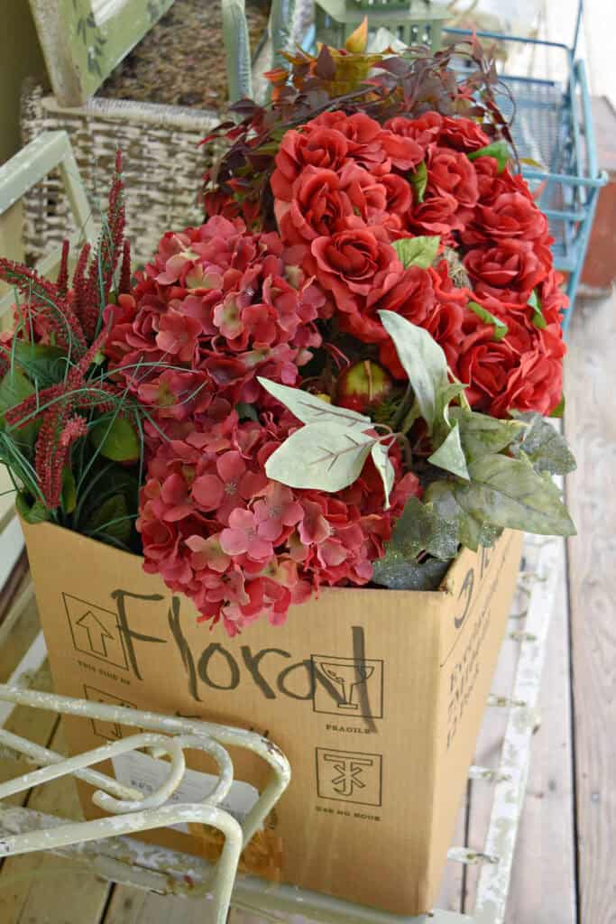 Red faux florals in box.