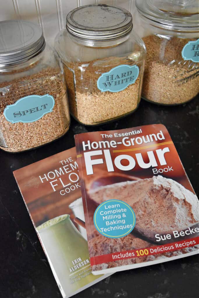 Freshly milled flour cookbooks and grains in jars.