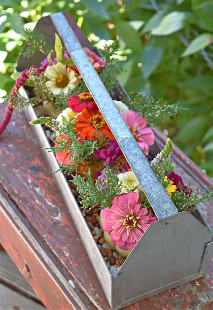 Old metal tool trug floral arrangement.