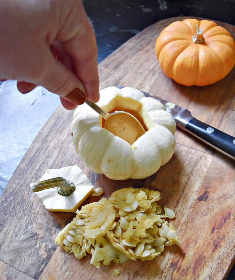 Taking seeds out of mini pumpkins.