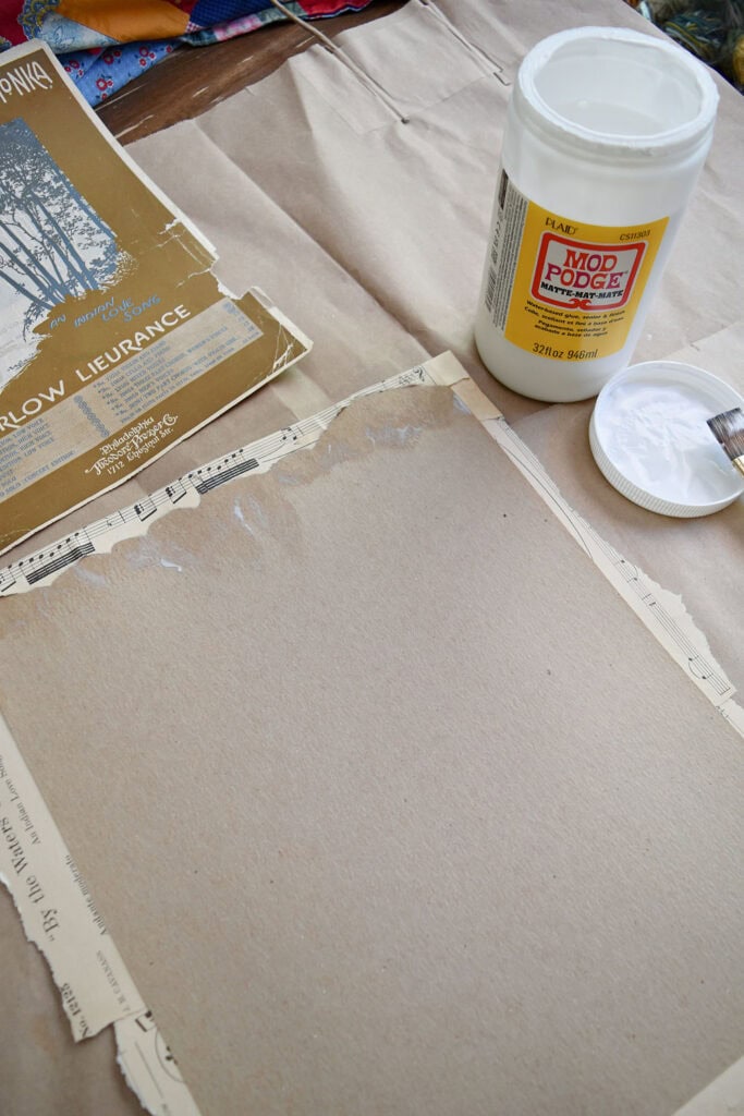Crafting vintage sheet music into upcycled art with modge podge.