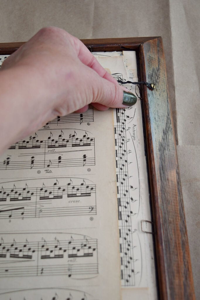 Gluing old sheet music down.