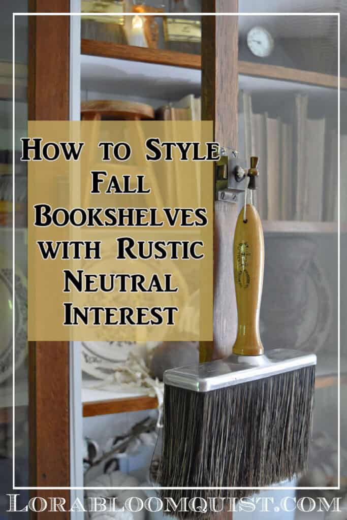 Glass cabinet Fall bookshelf display with old books, transferware and vintage paintbrushes.