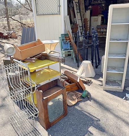 Pile of vintage finds in driveway.