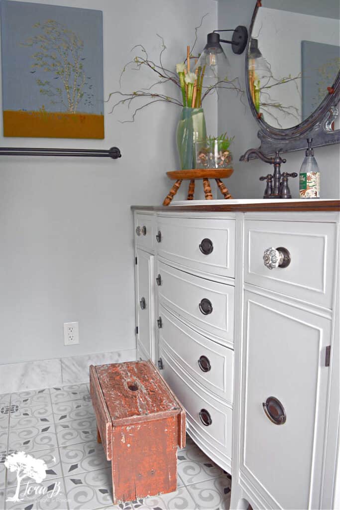 Old stool next to bathroom sink