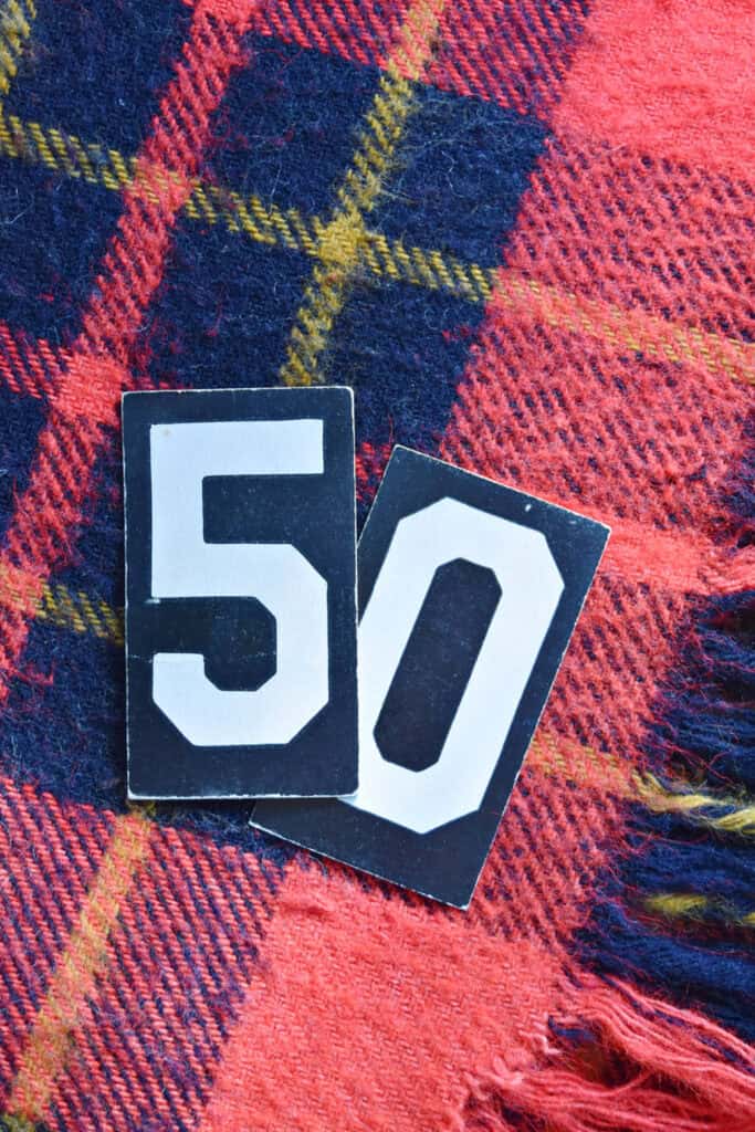 Paper letter 50 on plaid blanket