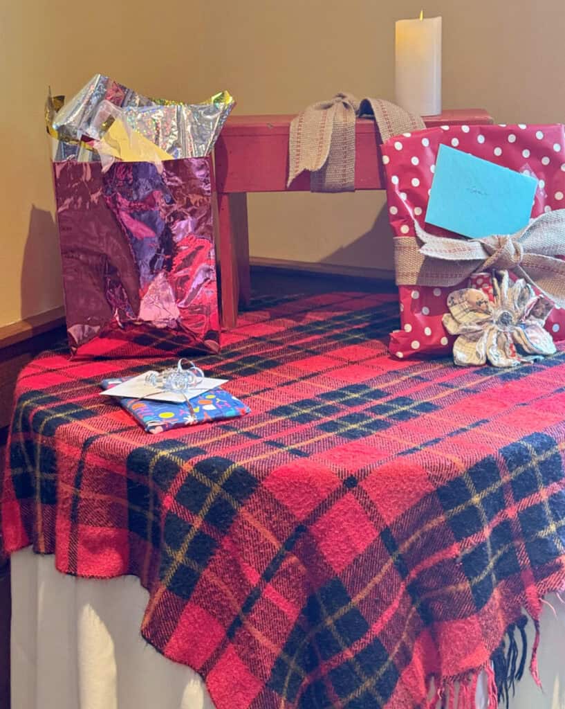 Plaid blanket on gift table.