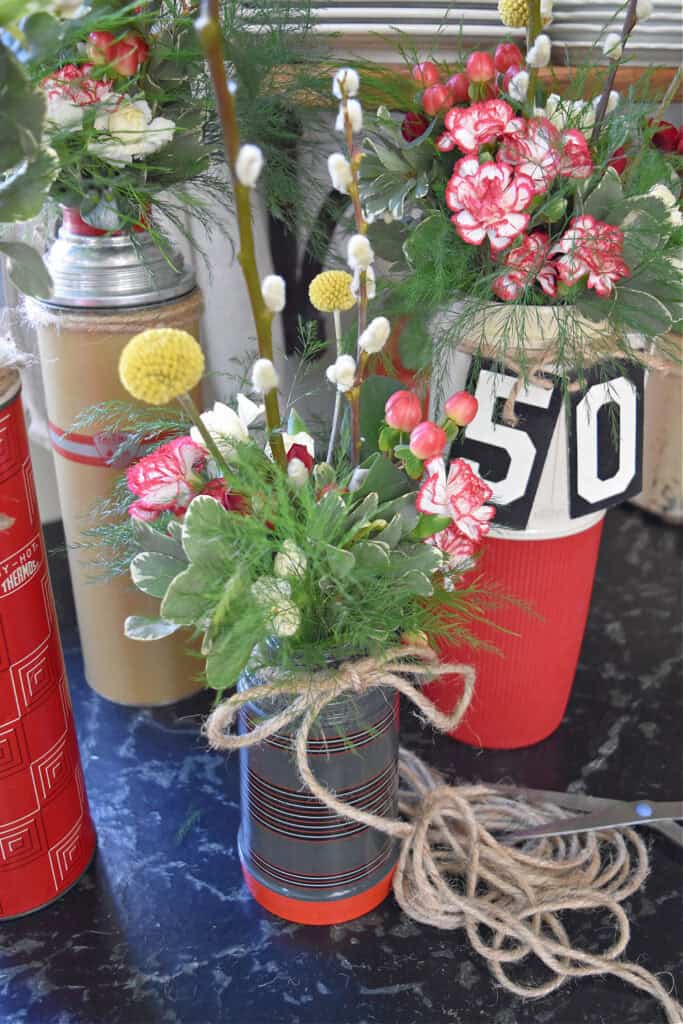 Vintage red thermoses and fresh flowers.