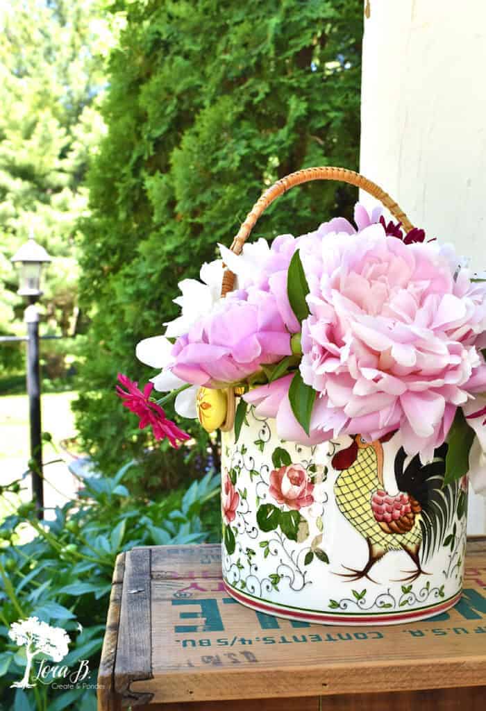 Pretty fresh cut peonies in a vintage rooster container.