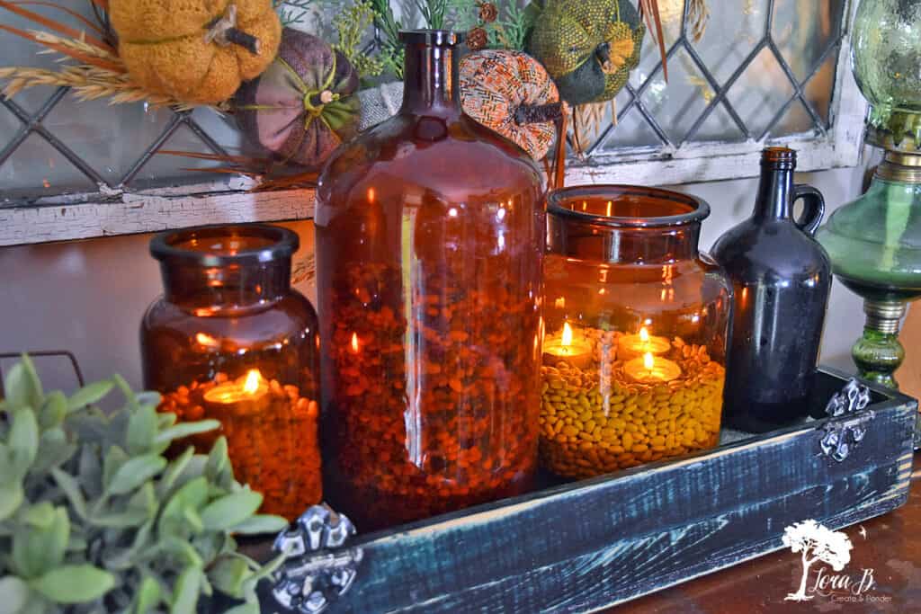 Amber glass vessels with dried legumes as decor.