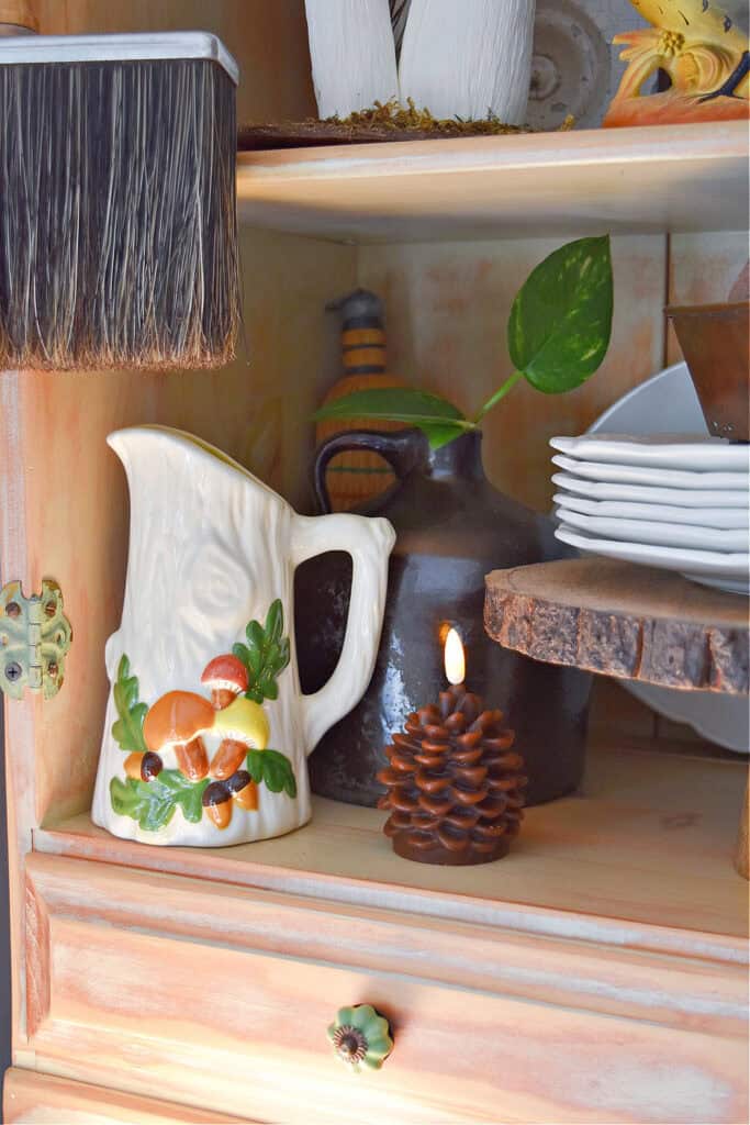 Vintage mushroom pitcher displayed on fall shelves.