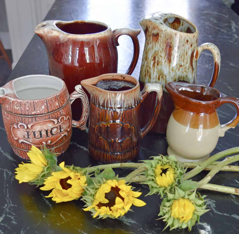 Collection of brown pottery pitchers.