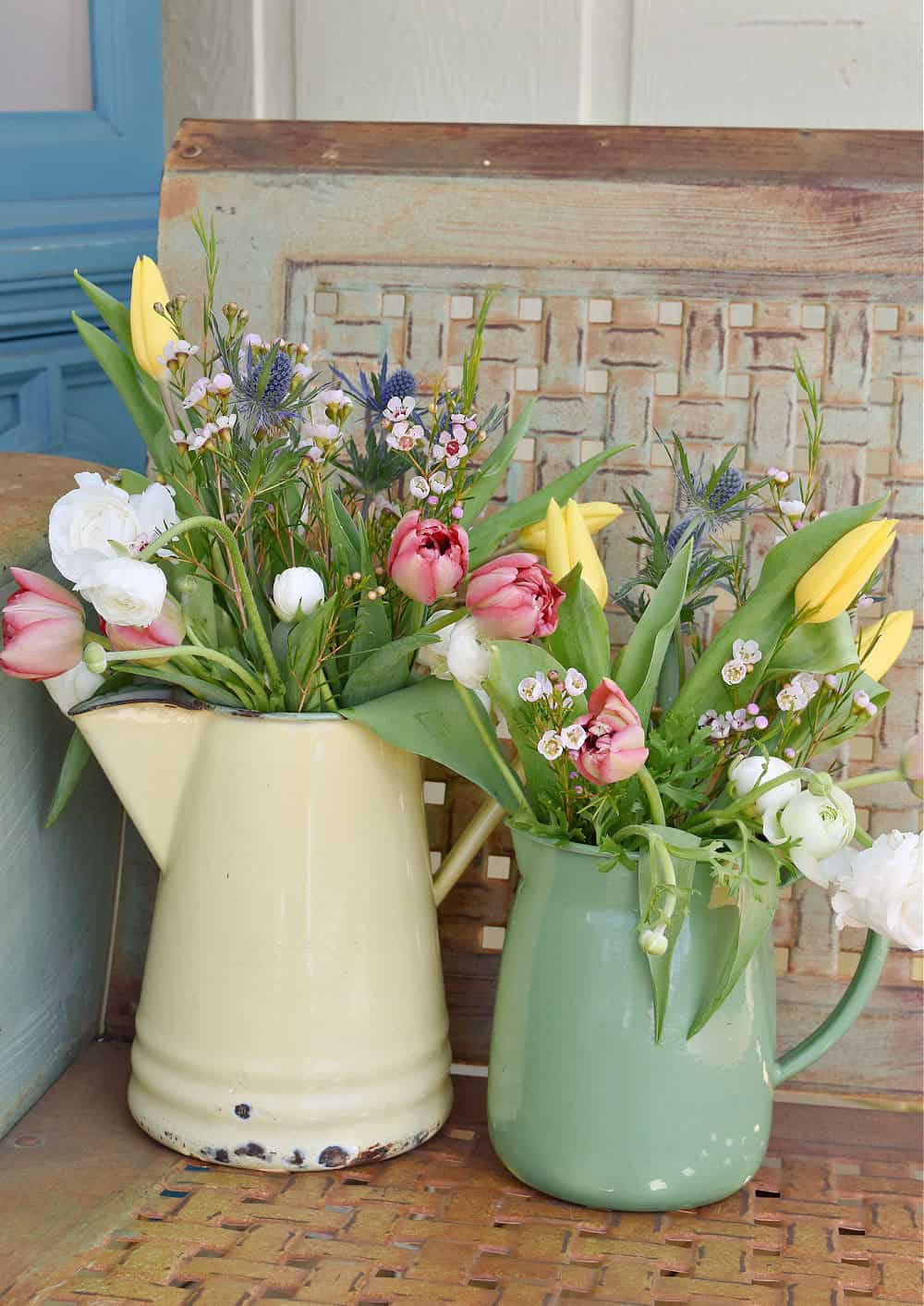 Spring flowers in vintage enamelware pitchers.