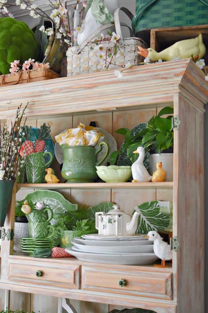 Green cabbage ware display in hutch.