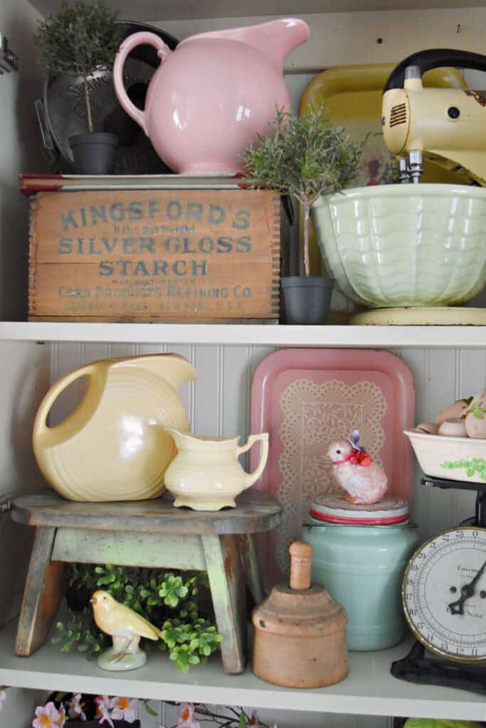 Spring vintage decor on kitchen shelves.