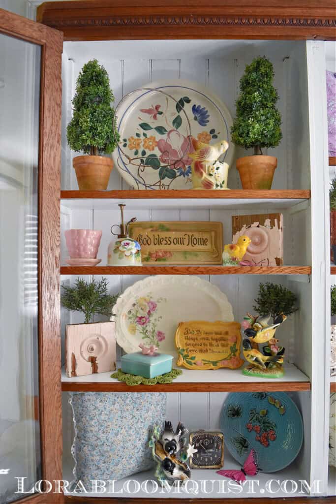 Bookshelves with vintage Spring decor finds.