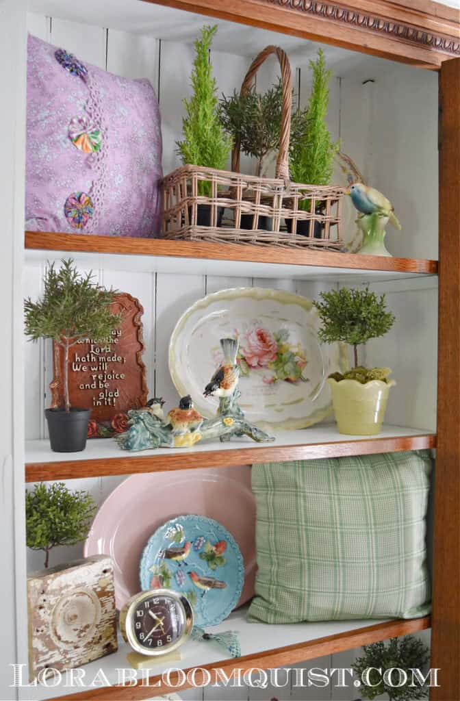 Bookshelves with vintage Spring decor finds.