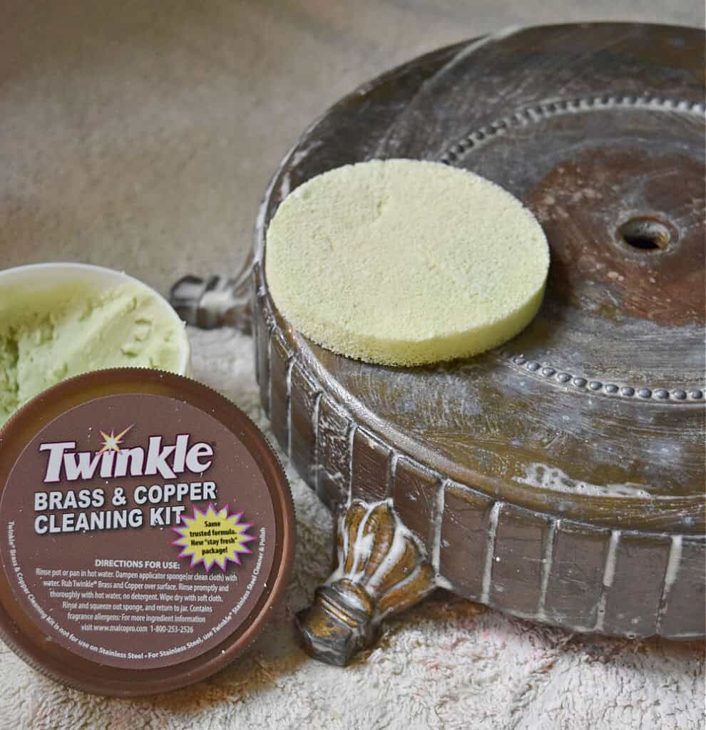 Polishing a vintage brass lamp base.