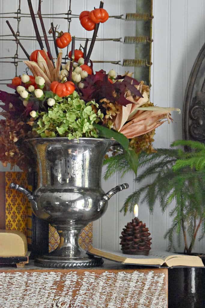 Fall floral arrangement in vintage silver ice container.