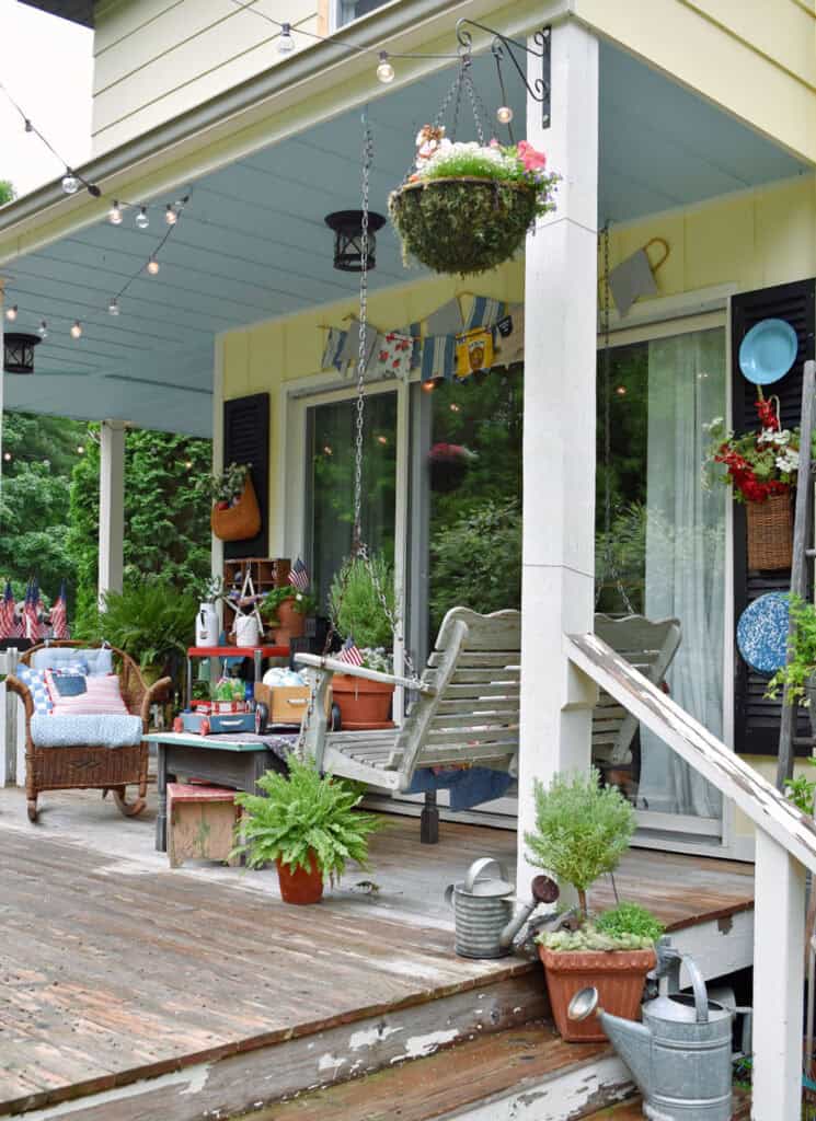 Patriotic porch decor with thrifted vintage finds for outdoor summer farmhouse decorating.