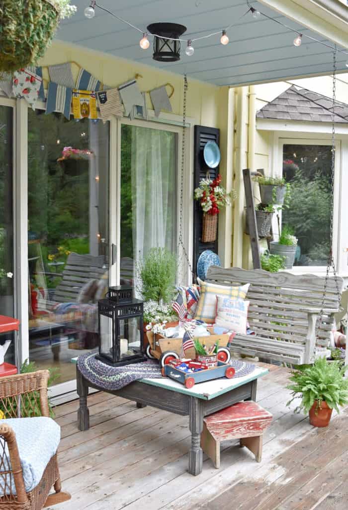 Patriotic porch decor with thrifted vintage finds for outdoor summer farmhouse decorating.