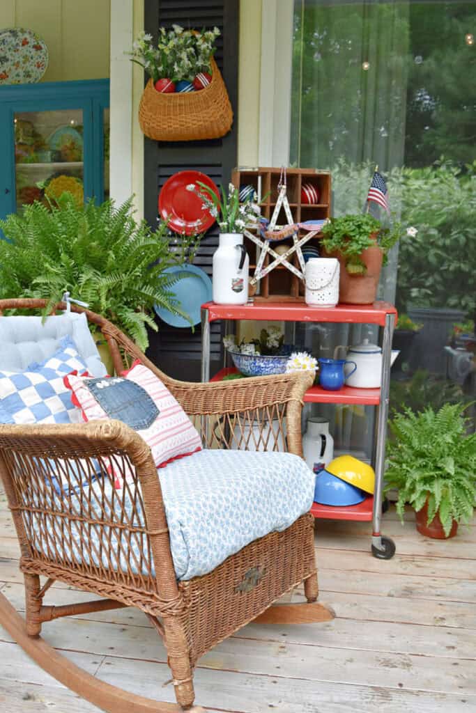 Wicker chair and vintage enamelware as Patriotic porch decor.