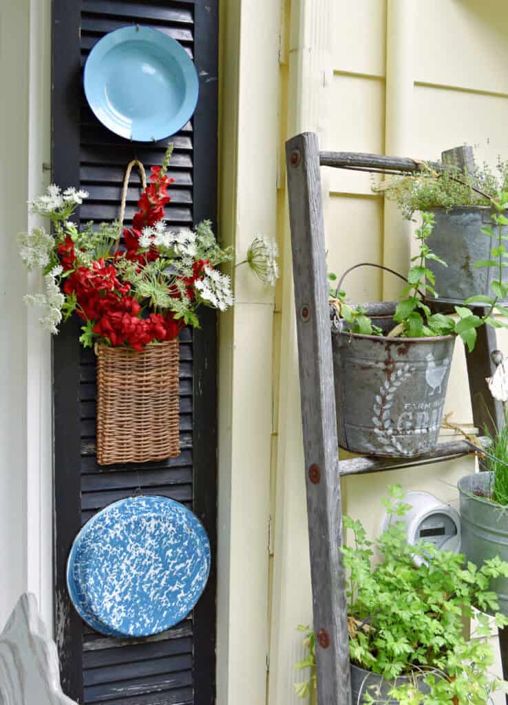 Thrifted finds on black shutter as summer porch decor.
