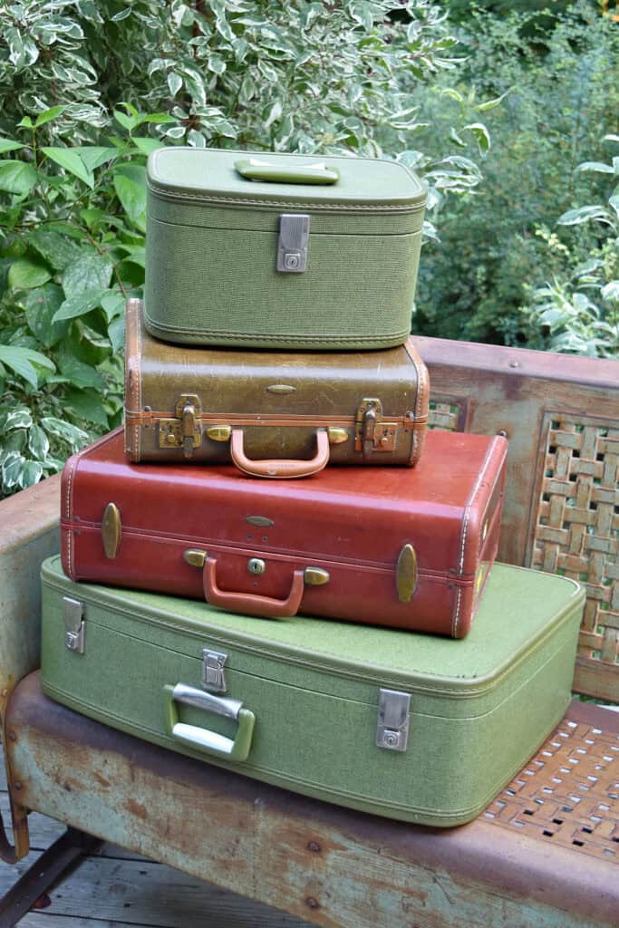 Stack of brown and green vintage suitcases.
