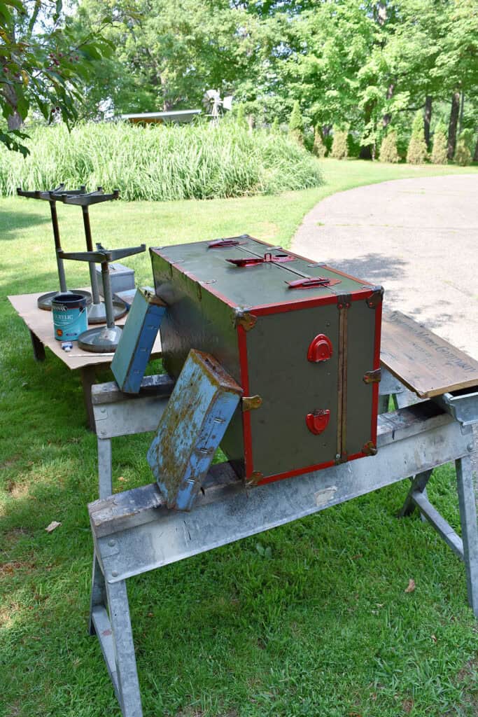 Vintage army trunk, metal drawers and stools drying on sawhorses.