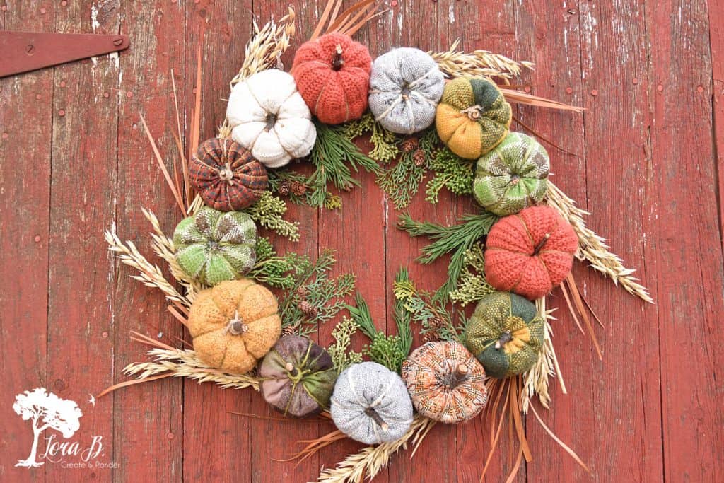 DIY fabric pumpkin wreath made from upcycled thrifted fabrics.