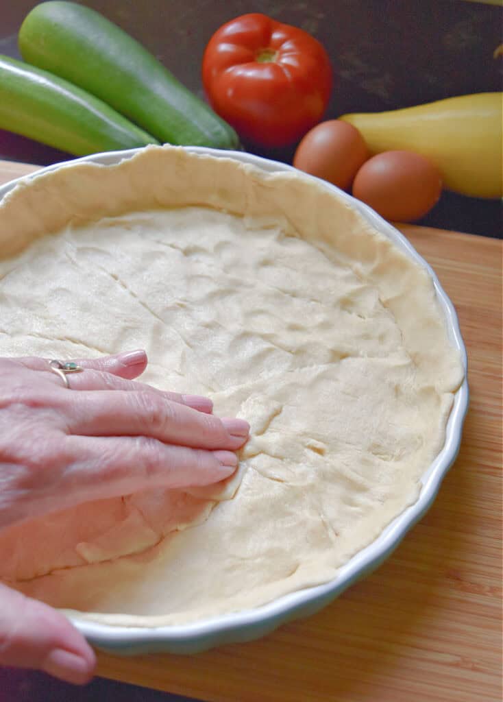Crescent roll crust in quiche pan.