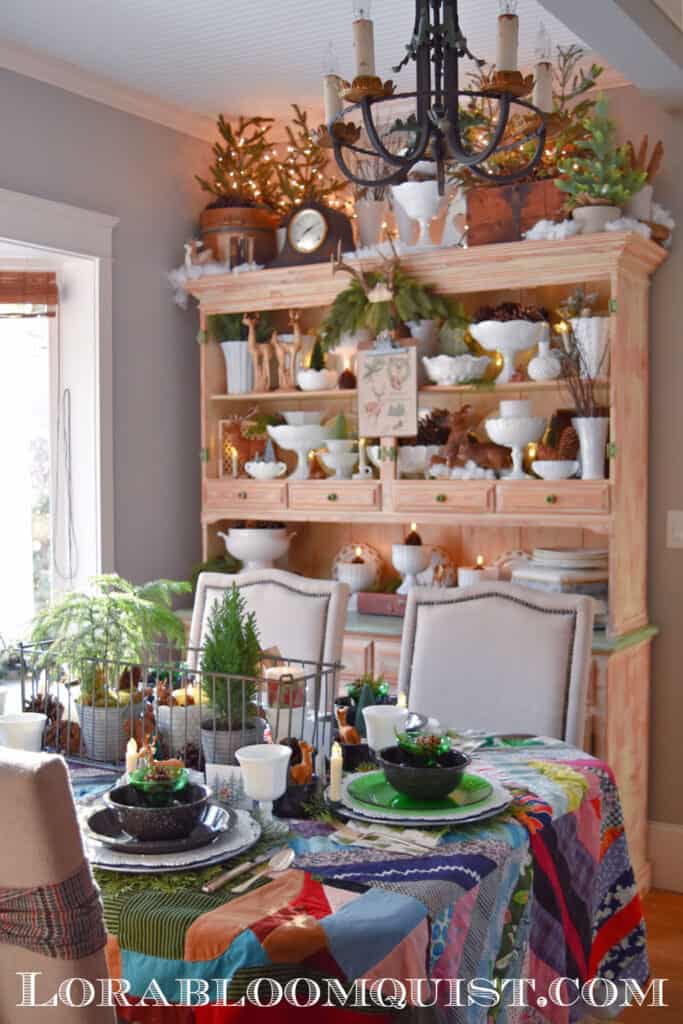 Woodland themed Christmas dining room hutch and table with vintage quilt.