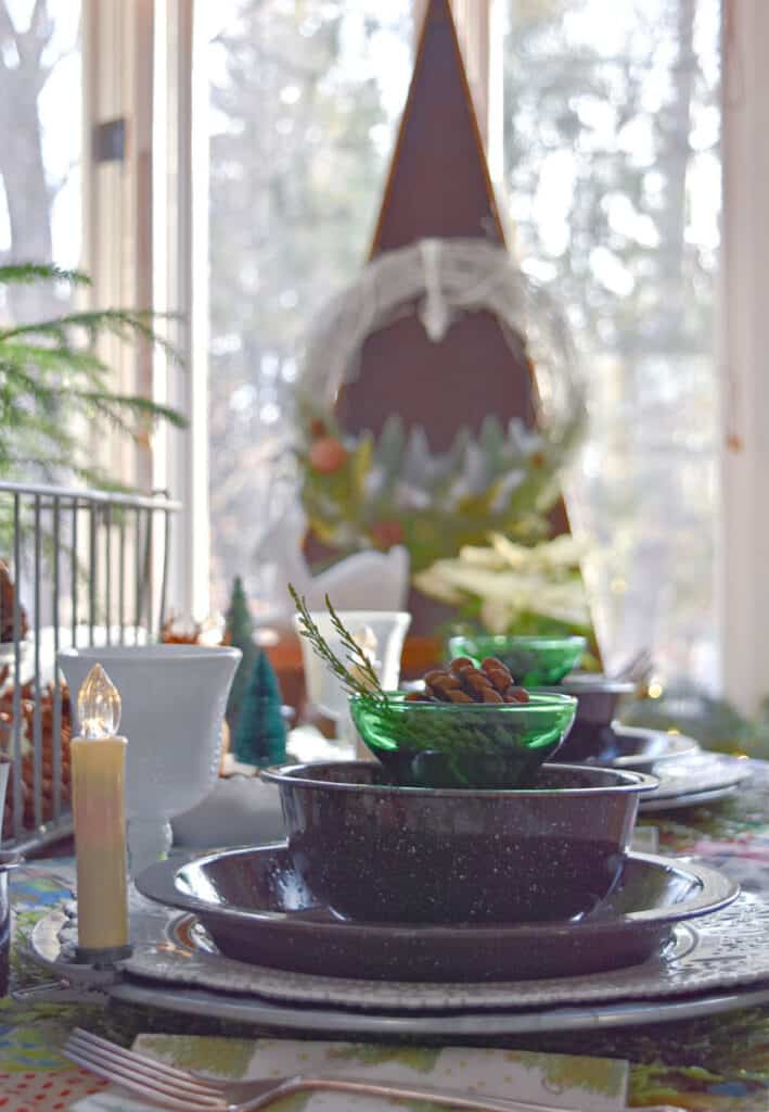 Christmas table setting with enamelware dishes.