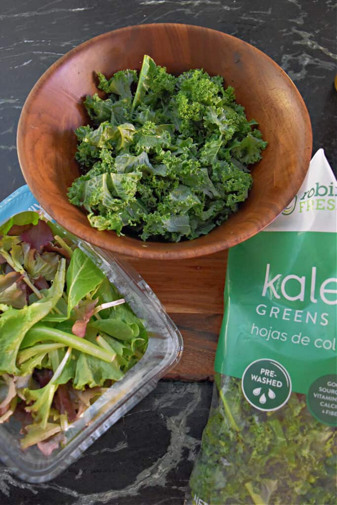 Kale and lettuce greens in wooden bowl.