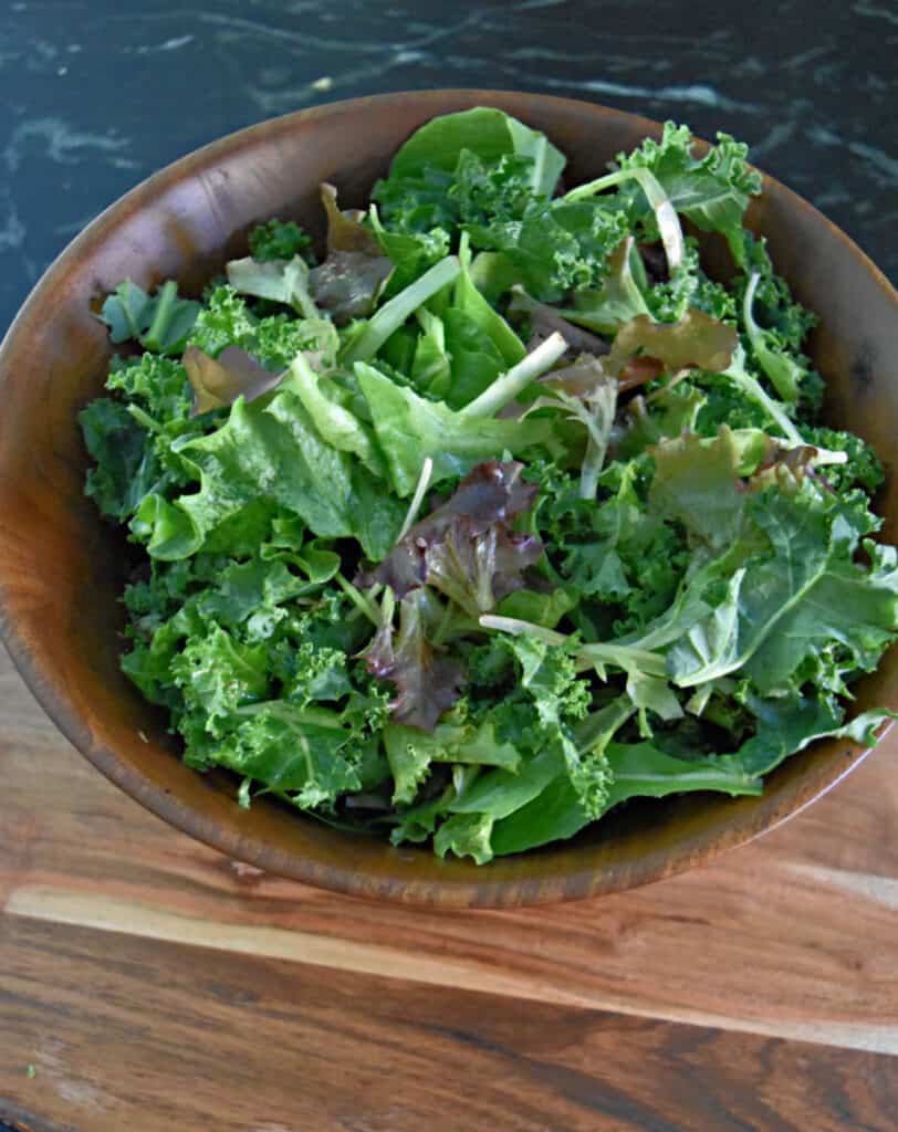 Kale and lettuce greens in wooden bowl.