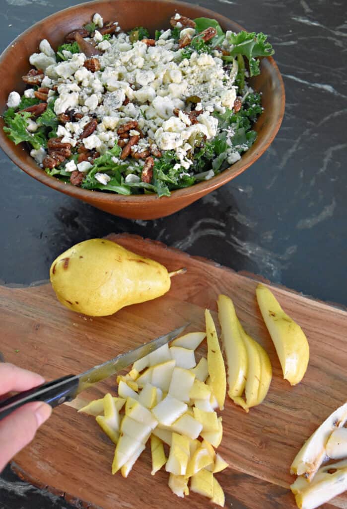 Cutting up fresh pear to add to green salad.