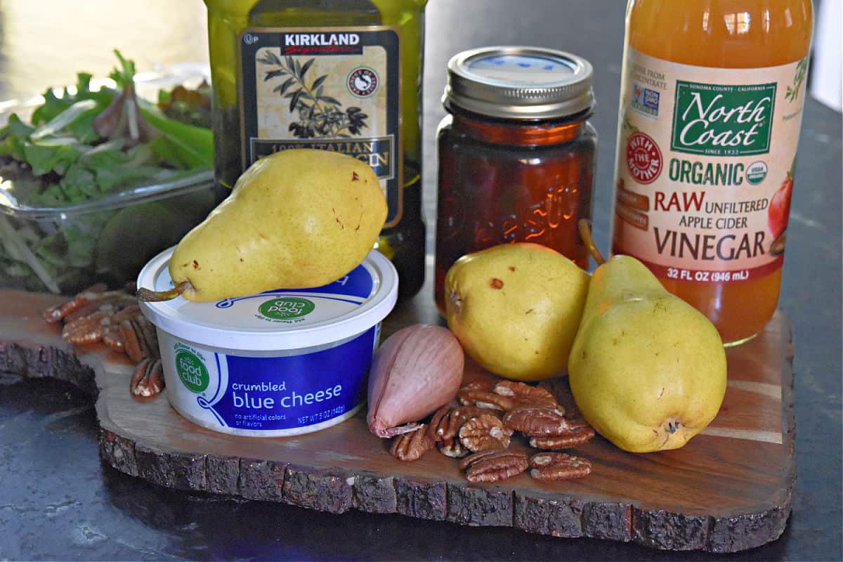 Pear Gorgonzola salad ingredients on wood cutting board.