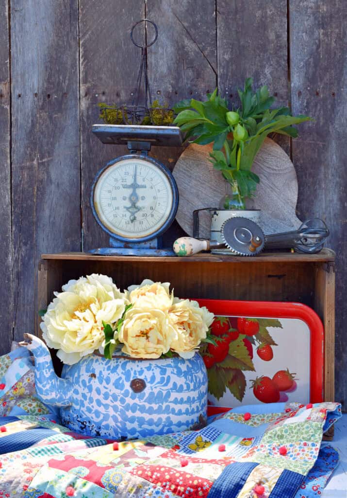 Vintage blue kitchen scale, enamelware coffeepot and patchwork quilt display.