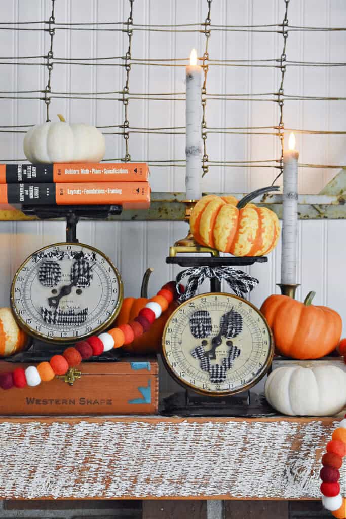 Vintage kitchen scales decorated as jack o lantern with pumpkins.