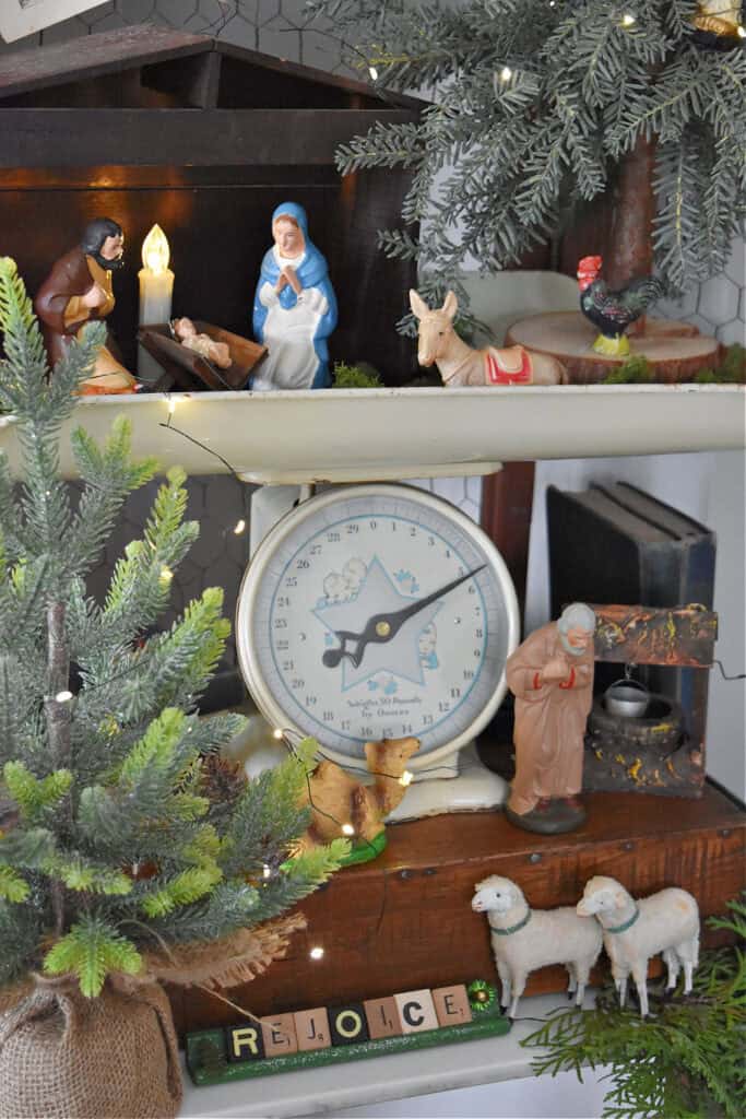 Vintage baby scale decorated with nativity creche.